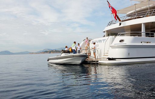 a family board their luxury yacht away from the coast of italy