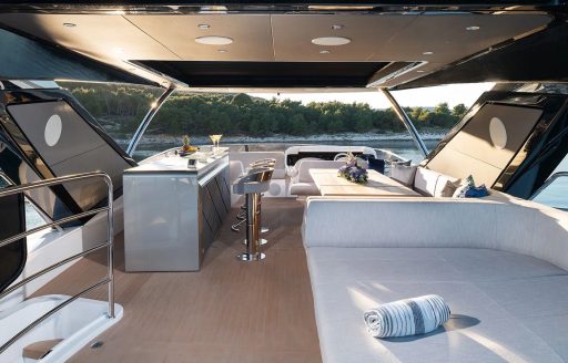 Flybridge onboard charter yacht MOWANA, wet bar to port side with seating to starboard