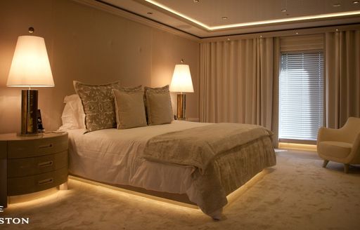 Master suite with bed and floor-to-ceiling window on luxury yacht Odessa II