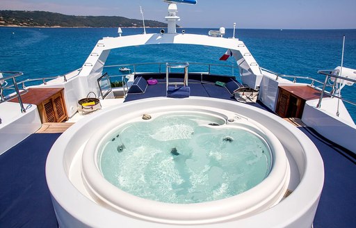 Sun deck with large jacuzzi on board luxury charter yacht MIRAGGIO