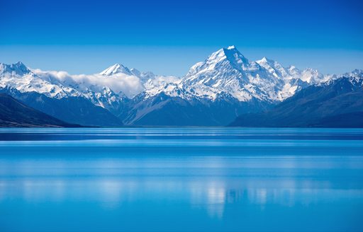 Amazing blue waters of Lake Tekapo against a backdrop of mountains
