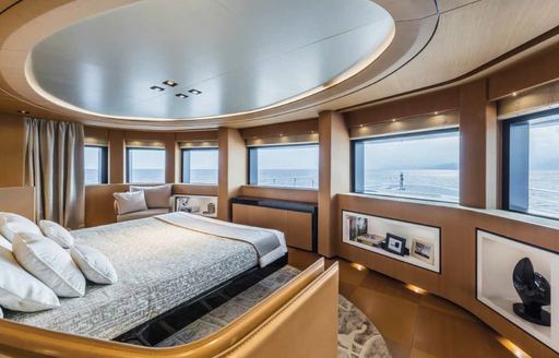 large bed in master suite on superyacht SUERTE