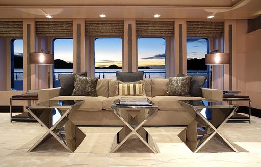 lounge area with large windows in main salon of luxury yacht VICKI