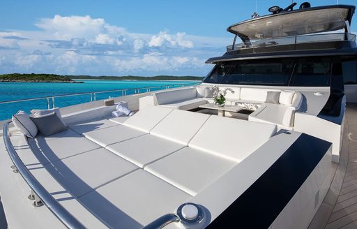 Large sunpad on the bow of charter yacht ENTREPRENEUR, surrounded by views of the sea and the bridge in the background