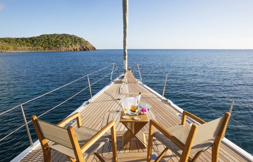 table and chairs on foredeck of luxury yacht MUZUNI 