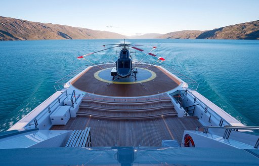 helicopter lands on helipad aboard luxury yacht CLOUDBREAK