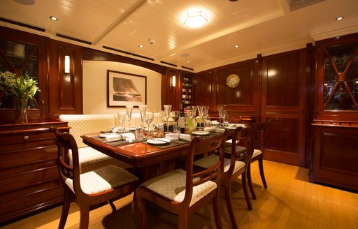 Formal dining area in sunken deckhouse on board charter yacht RAINBOW