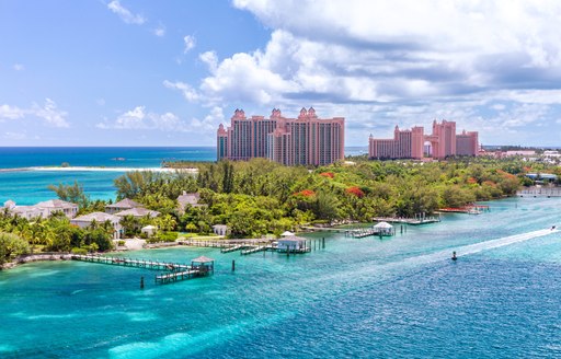 Landscape shot of Nassau in the Bahamas with tall buildings and blue sea