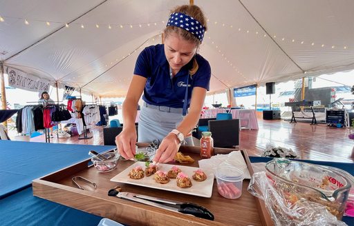 A superyacht chef preparing a dish for a chef competition at the Newport Charter Yacht Show