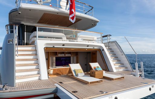 Overview of the beach club onboard charter yacht MANA I, two sun loungers on a swim platform