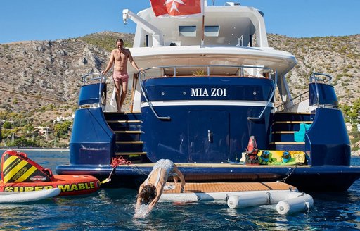 Aft view of charter yacht Mia Zoi at anchor, with floating water toys adjacent