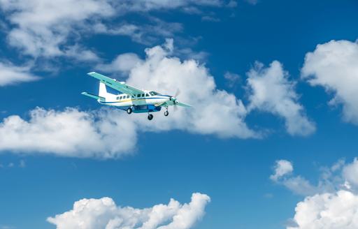 little chartered plane flying in the sky above the caribbean
