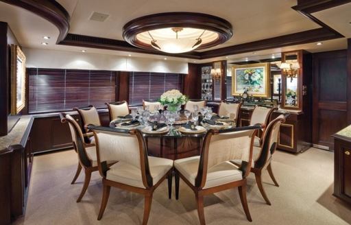 circular dining table in main salon of luxury yacht ‘Sea Dreams’ 