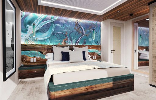 Guest cabin onboard charter yacht KING BENJI, double berth centered with marine visuals in the background