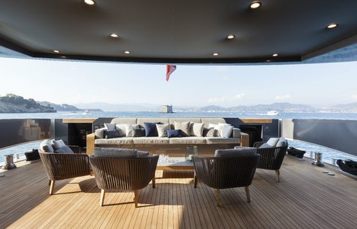 chic outdoor lounge on the main deck aft of luxury yacht Lucky Me 