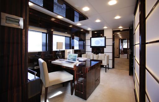 Office on superyacht GEMS II, with desk and TV