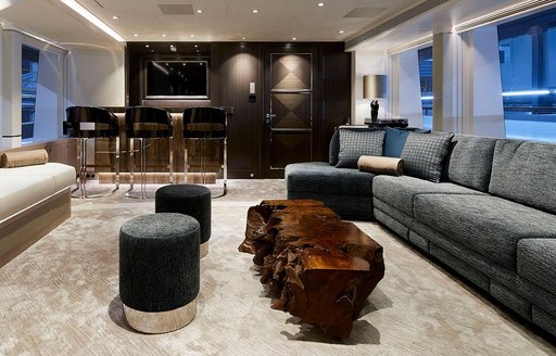 superyacht irisha salon with wood table and plush carpets