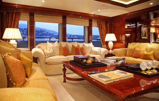 Seating area onboard private yacht charter ST DAVID, cream sofas facing in with large coffee table