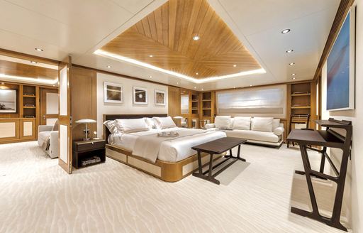 Master cabin onboard charter yacht SOLAFIDE, central berth facing starboard with seating area aft