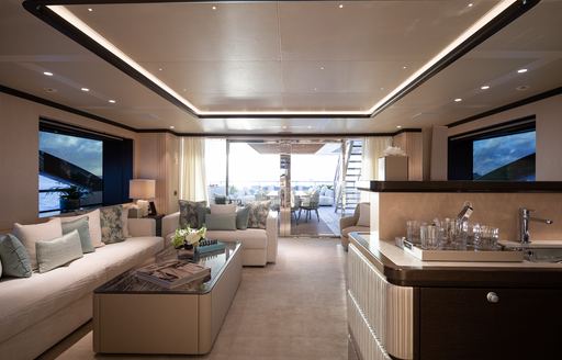 Neutral interiors onboard charter yacht FANTASEA, spacious lounge area with plush white seating