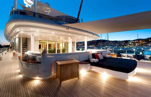 Comfortable alfresco seating area on deck of luxury yacht Triple 7