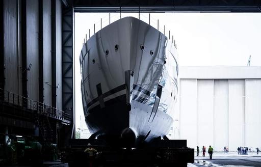 Close up view of the bow on superyacht CALI moving backwards out of construction shed