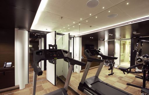 Gym equipment on luxury yacht KATINA with mirror panelled wall