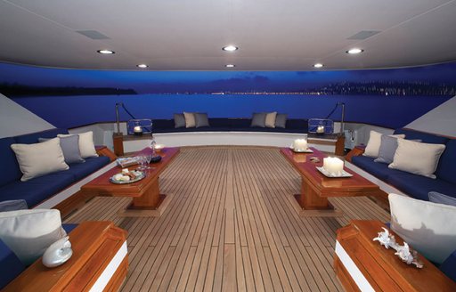 Shaded seating area on deft deck aboard motor yacht Shake N Bake