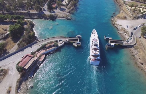 An aerial image of luxury yacht St David cruising through the Corinth Canal