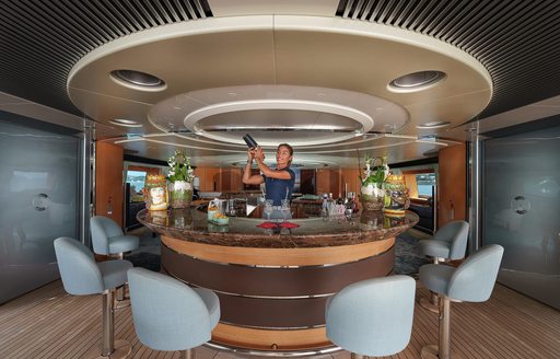 Wet bar onboard sailing yacht charter MALTESE FALCON with a crew member mixing cocktails
