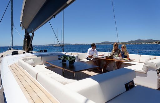 charter guests relax together in the cockpit on board charter yacht SHAMANNA 