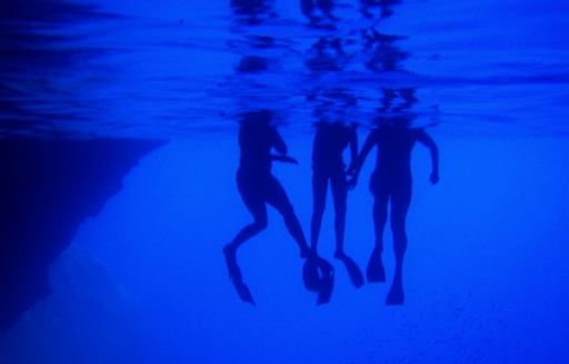 Swimmers legs underwater at the Blue grotto on the island of Kastelloriz