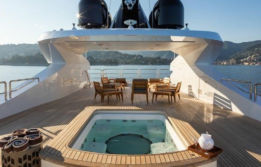 Deck Jacuzzi onboard charter yacht ALFA, with seating area in the background