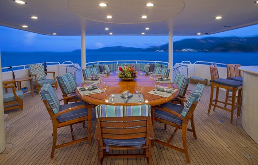 aft deck dining as night falls on board luxury yacht ARIOSO
