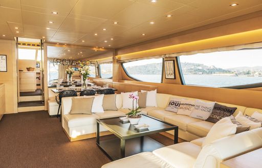 Main salon onboard charter yacht THIS IS MINE, lounge area forward surrounded by wide windows
