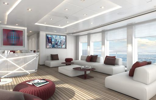Main salon onboard charter yacht HOME, white upholstered sofas and chairs underneath large windows, facing a wet bar