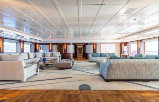 Main salon onboard charter yacht CARINTHIA VII, large lounge area with wide windows to both sides