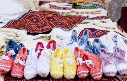 Local booties and clothing for sale on a market stall in Dubrovnik, Croatia