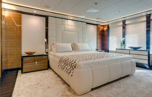 beautiful master suite with leather panel headboard aboard superyacht ‘Party Girl’ 