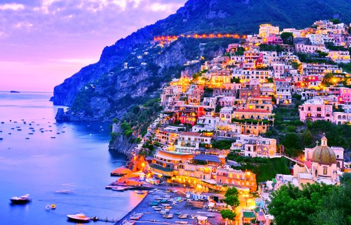 Beautiful pastel-hued houses on the Amalfi coast at sunset, Italy