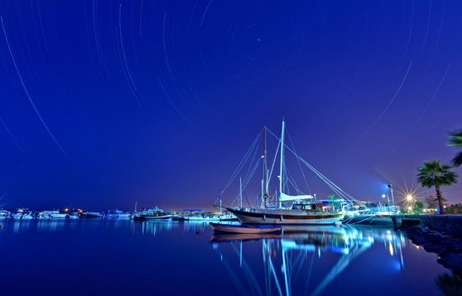 Croatian gulets docked at a marina at night