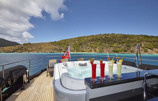 sundeck spa pool on luxury yacht grey matters with cocktails in foreground