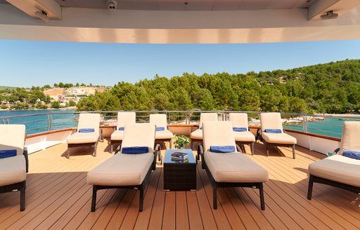 Sunloungers and blue towels onboard private yacht charter QUEEN ELEGANZA