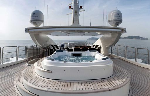Sundeck of charter yacht PANAKEIA, with spa pool in foreground and dining in background