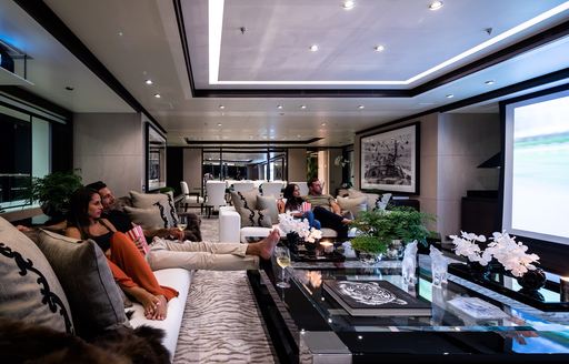 Guests enjoying a movie on board charter yacht TRIUMPH