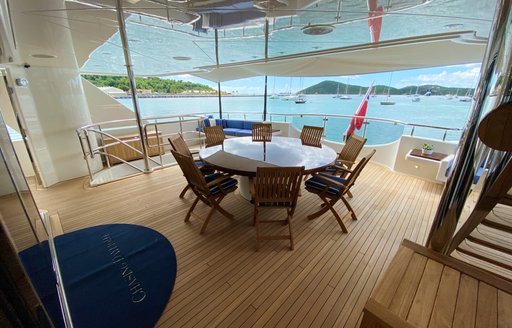 Covered round table on deck of superyacht Chasing Daylight