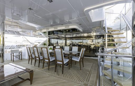 rectangular alfresco dining table on main deck aft of superyacht King Baby 
