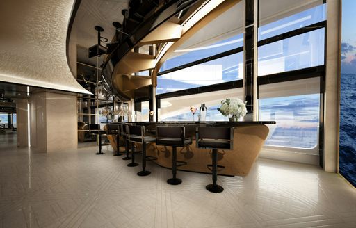 A wet bar onboard charter yacht KISMET, with multiple black stools facing full-height windows