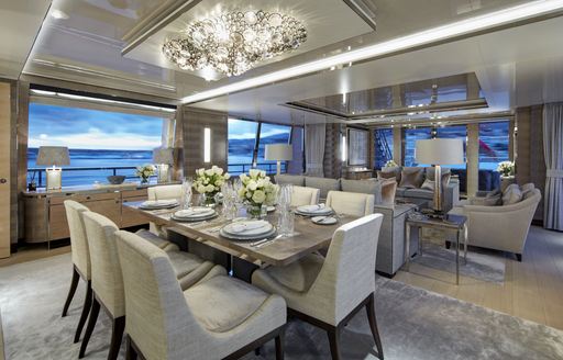 Interior dining area onboard charter yacht LADY VICTORIA with lounge area in background
