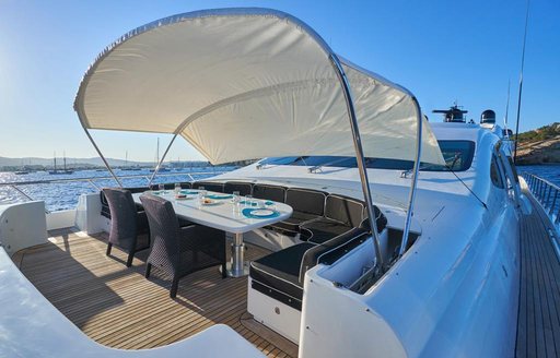 Foredeck seating area onboard boat charter MRS GREY with bimini extended